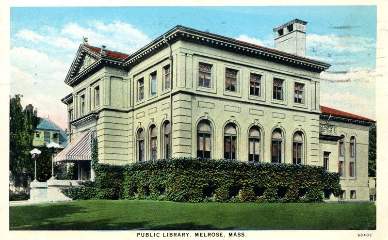 A color postcard of the library behind a hedge and a wide green lawn