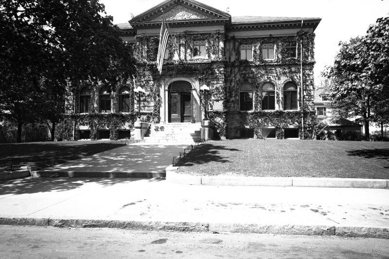 The ivy-covered library front in winter, with snow along West Emerson Street